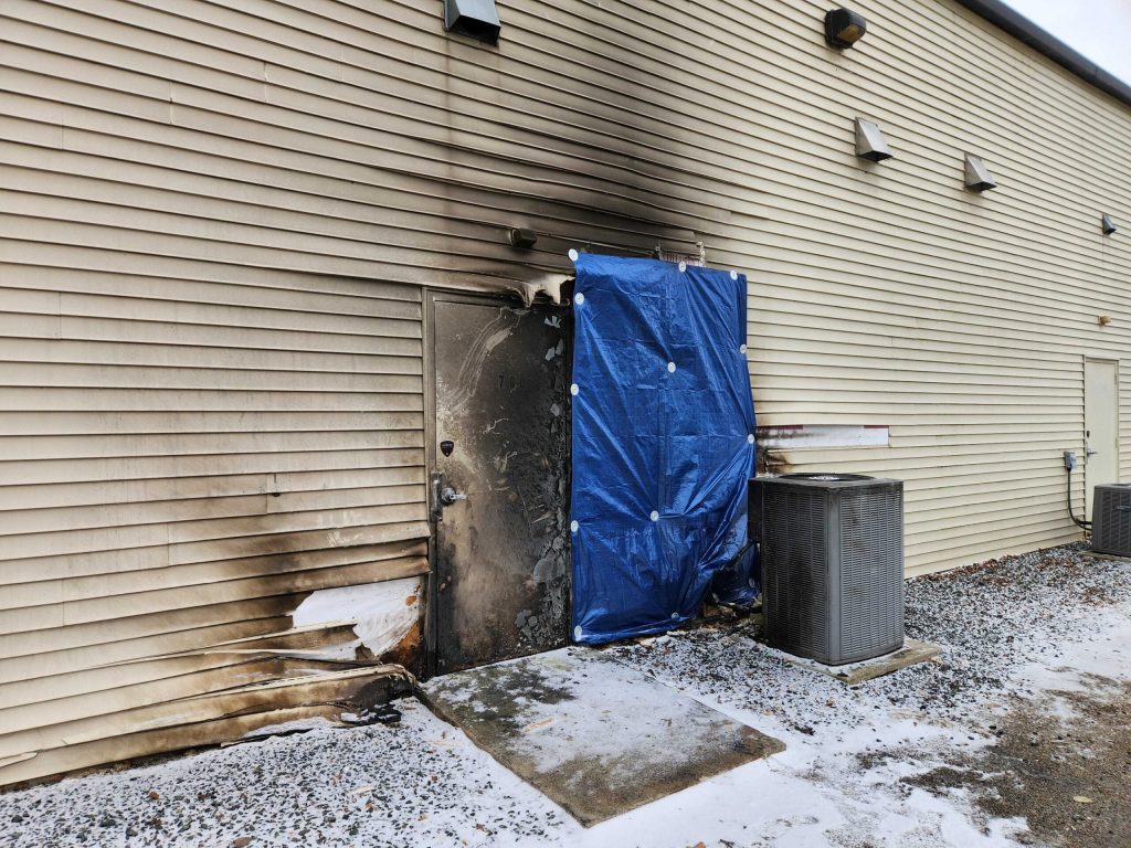A tarp covers an area where a fire started behind U.S. Rep. Glenn Grothman’s office in Fond du Lac on Jan. 22, 2025. Joe Schulz/WPR