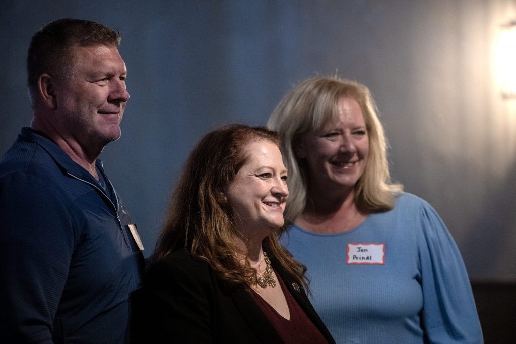 Wisconsin Supreme Court candidate Maria Lazar takes photos with attendees at a campaign event Tuesday, March 10, 2026, in Germantown, Wis. Angela Major/WPR