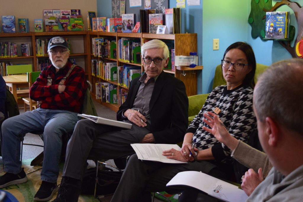 Gov. Tony Evers and DNR Secretary Karen Hyun speak with Campbell residents about the local impacts of PFAS contamination during an event on Tuesday Feb. 4, 2025. Hope Kirwan/WPR