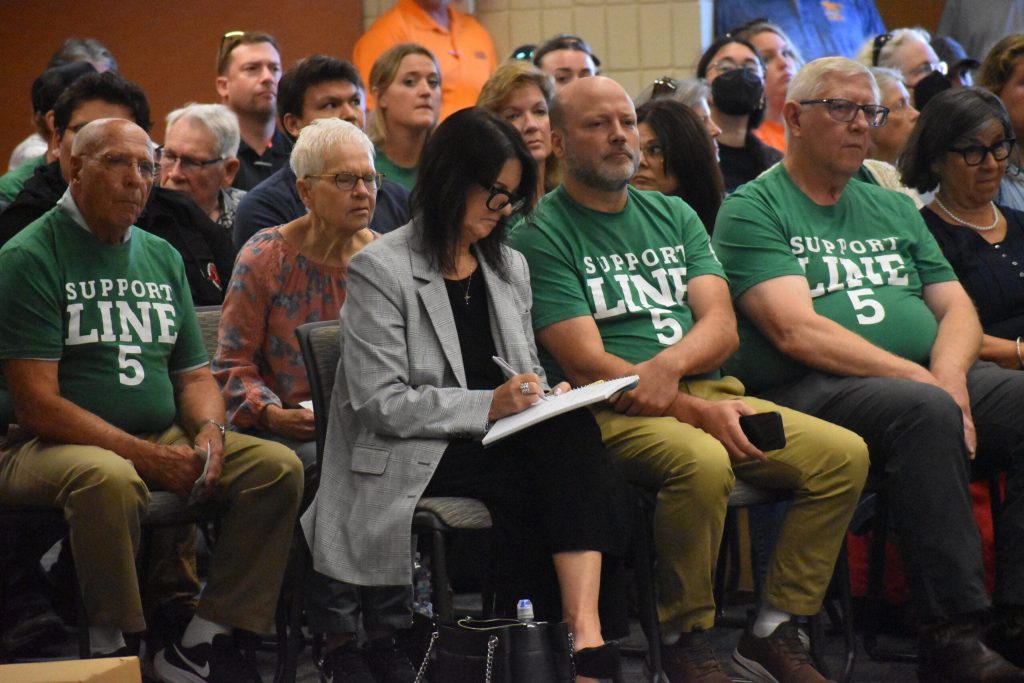 Supporters of the Line 5 relocation project listen to opening statements at a contested case hearing in Ashland on Aug. 12, 2025. The Bad River tribe and environmental groups petitioned for the hearing as part of a challenge to key permits for the project. Danielle Kaeding/WPR