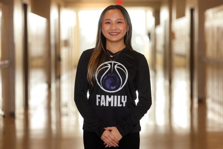 Eva Vang, senior, poses for a portrait at Hmong American Peace Academy in Milwaukee. (Photo by Jonathan Aguilar / Milwaukee Neighborhood News Service / CatchLight Local)