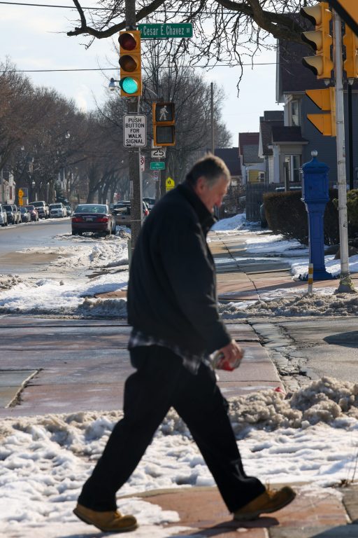 A man walks along South Cesar E. Chavez Drive. (Photo by Jonathan Aguilar / Milwaukee Neighborhood News Service / CatchLight Local)