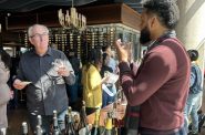 Milwaukee Wine Academy co-founder Tim Cole (right) speaks to a guest at the 2025 MKE Wine Weekend.