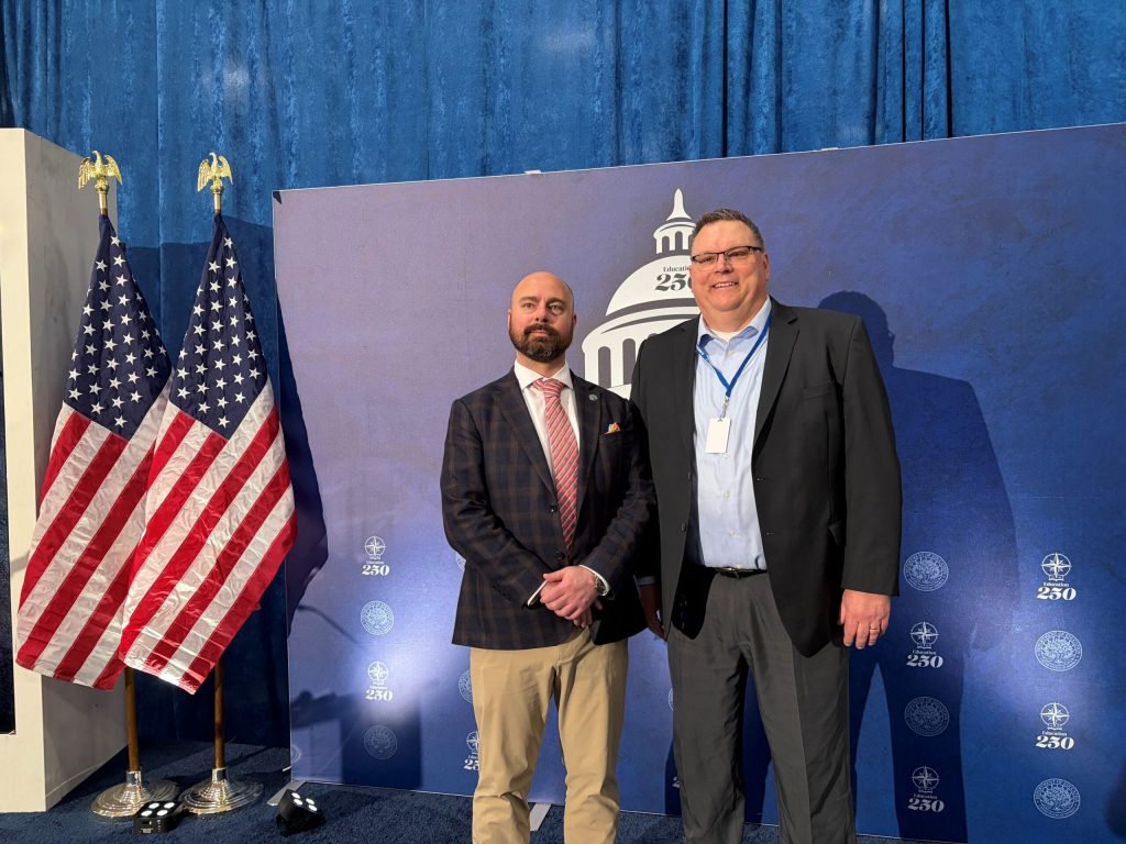 Murray Bessette, deputy assistant secretary for the Department of Education, left, and Principal Brett Gruetzmacher. Corrinne Hess/WPR