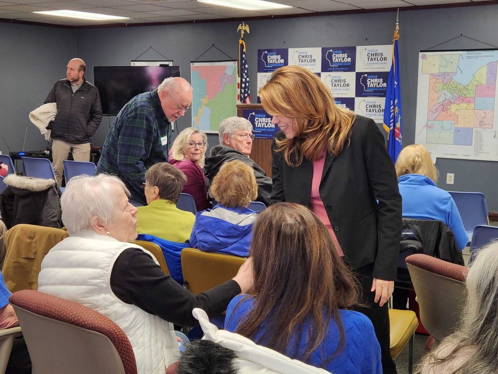 Liberal Wisconsin 4th District Court of Appeals Judge Chris Taylor mingles with supporters, Friday, at the Brown County Democratic Party headquarters in Green Bay during her final tour before the April 7 Supreme Court election. Joe Schulz/WPR