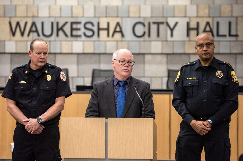 Waukesha Mayor Shawn Reilly, center, answers questions from reporters alongside Fire Chief Steve Howard, left, and Police Chief Dan Thompson, right, on Thursday, Nov. 17, 2022, at Waukesha City Hall in Waukesha, Wis. Angela Major/WPR