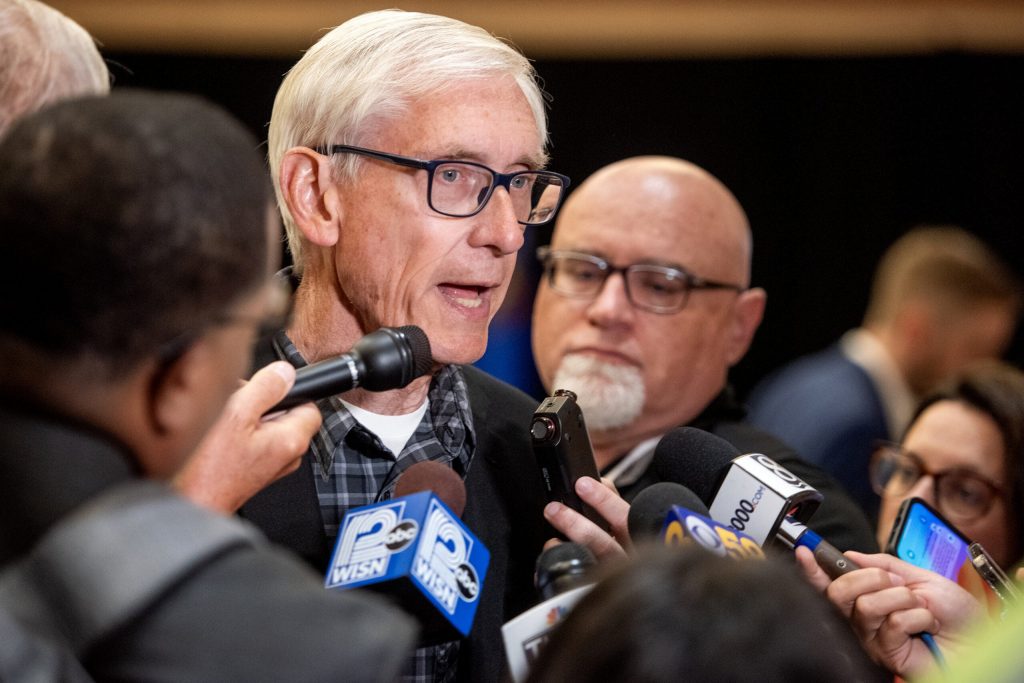 Gov. Tony Evers addresses reporters during the Wisconsin delegation breakfast Monday, Aug. 19, 2024, on the first day of the DNC in Chicago, Ill. Angela Major/WPR