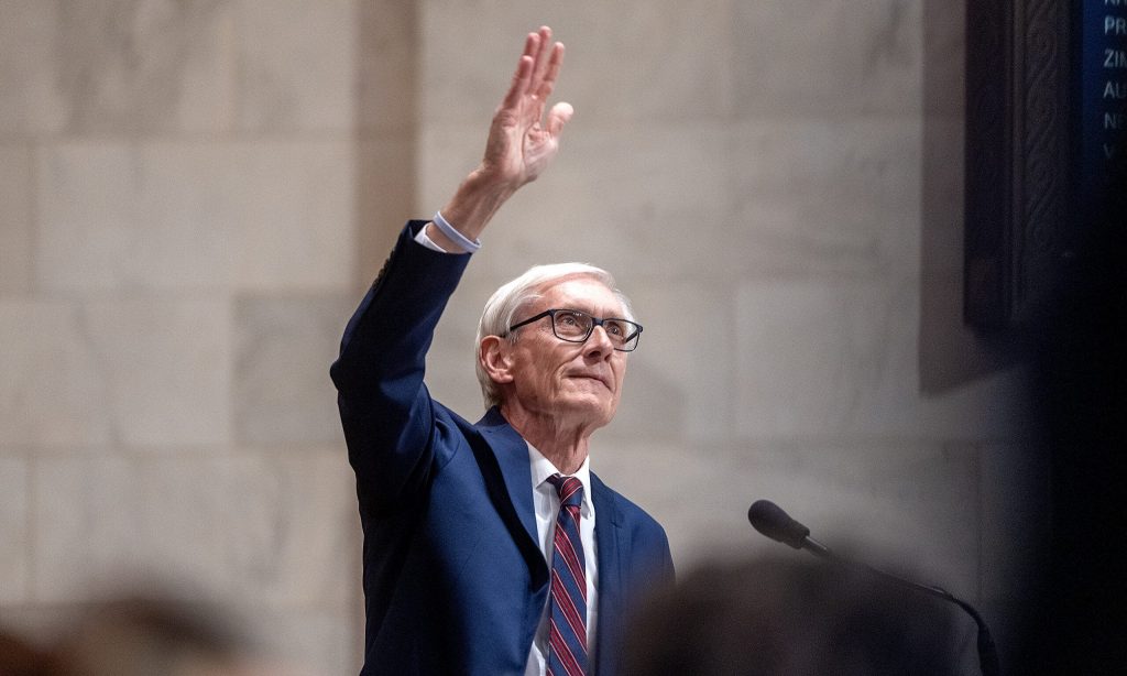 Gov. Tony Evers waves to people in the balcony before delivering the State of the State address Tuesday Feb. 17, 2026, at the Wisconsin State Capitol in Madison, Wis. Angela Major/WPR