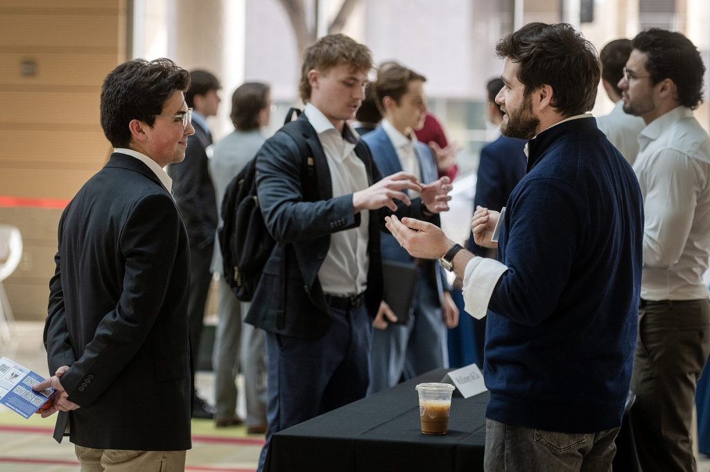 UW-Madison international business major Carlos Bello, left, mingles with fellow students and employer representatives at a networking event Friday, March 20, 2026, at UW-Madison in Madison, Wis. Angela Major/WPR