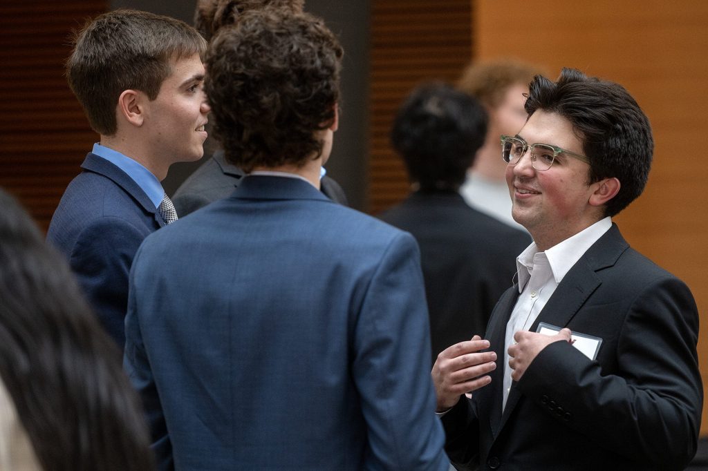 UW-Madison international business major Carlos Bello, right, speaks to other students during a networking event Friday, March 20, 2026, at UW-Madison in Madison, Wis. Angela Major/WPR