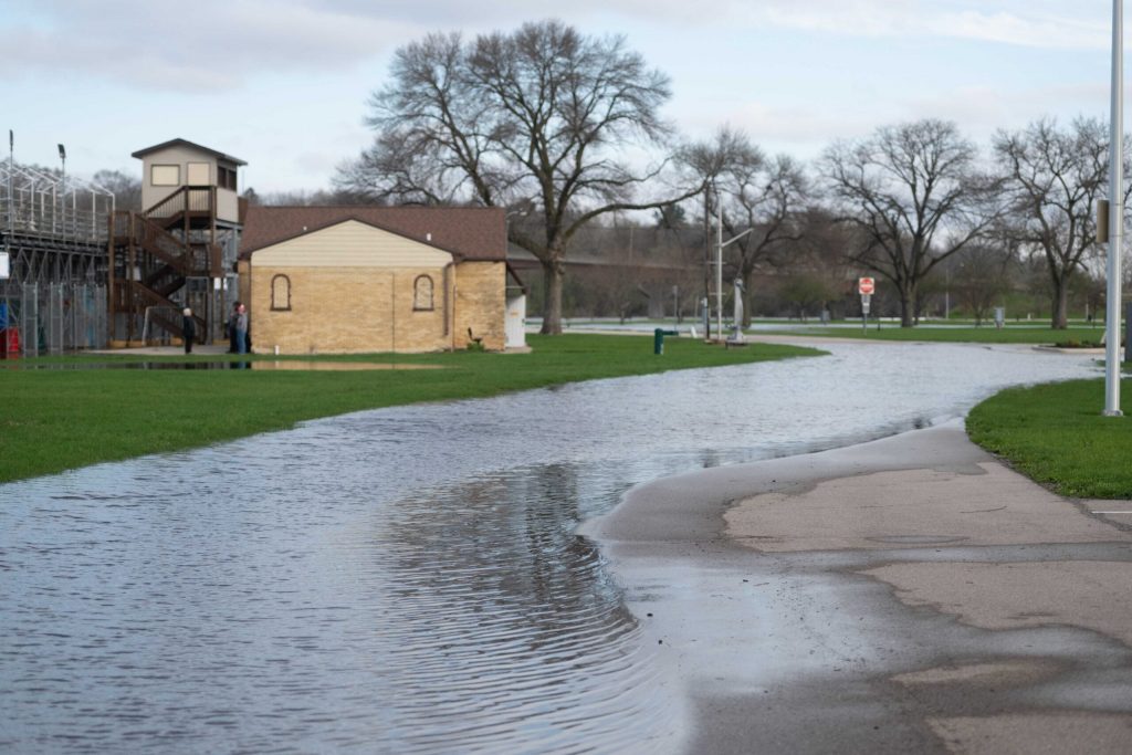 Roads and pathways are flooded at Traxler Park near the Rock River on Saturday, April 18, 2026, in Janesville, Wis. Angela Major/WPR