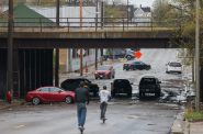 Several cars remained stuck underneath the railroad crossing bridge on West Burleigh Street after heavy rainfall caused flooding throughout Milwaukee on Thursday, April 16.  (Photo by Jonathan Aguilar / Milwaukee Neighborhood News Service / CatchLight Local)
