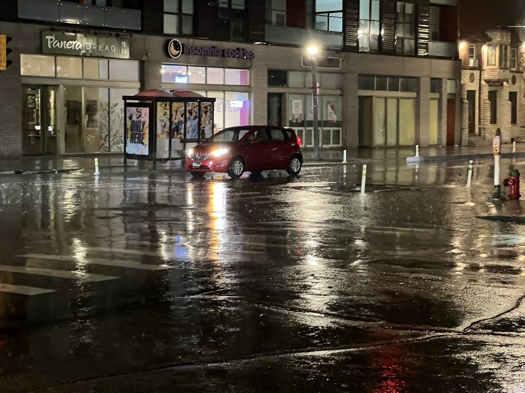Flooding on E. North Avenue pushed a manhole cover down the street. Photo by Jeramey Jannene.