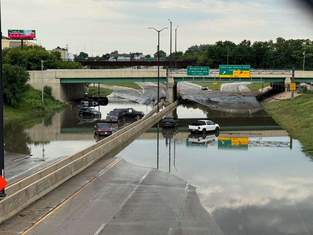 Vehicles are stuck on a flooded roadway at the exit to American Family Field in Milwaukee, Sunday Aug. 10, 2025. Evan Casey/WPR