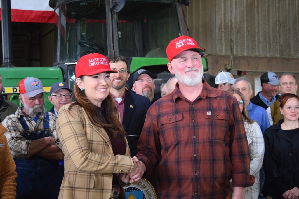USDA Secretary Brooke Rollins shakes hands with U.S. Rep. Derrick Van Orden, R-Prairie du Chien, during visit to dairy farm in Onalaska on Monday, April 27, 2026. Hope Kirwan/WPR