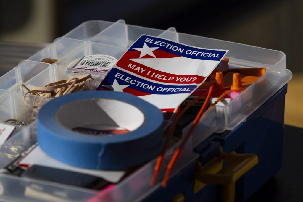 Election official stickers sit on a table during the spring election at Warner Park Community Recreation Center on April 7, 2026, in Madison, Wis. (Joe Timmerman / Wisconsin Watch)