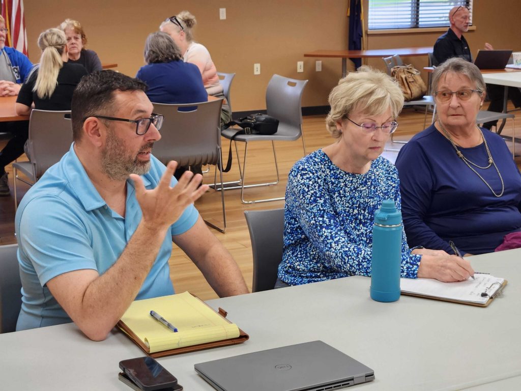 Chris Smith, an attorney hired by the village of Wrightstown, left, speaks to residents during a community listening session about data centers on May 19. Joe Schulz/WPR