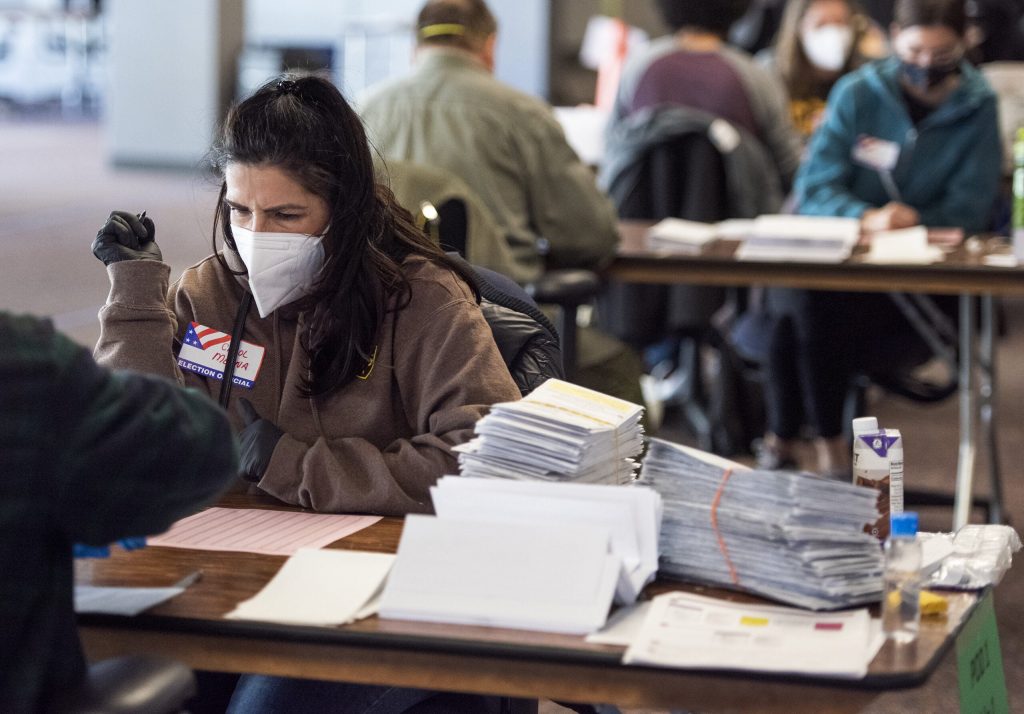A worker sorts through absentee ballots Tuesday, Nov. 3, 2020, at Milwaukee’s Central Count facility. Angela Major/WPR