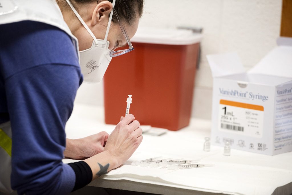 Jessica Coburn, an assistant professor at the UW-Madison School of Nursing, draws up COVID-19 vaccines while volunteering at the clinic in Jefferson County on Tuesday, Jan. 26, 2021. Angela Major/WPR