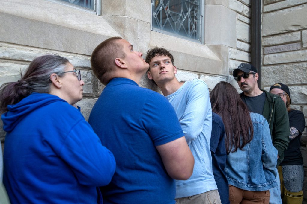 People listen as “A Mother of A Revolution!” Is performed Wednesday, May 20, 2026, at Immanuel Evangelical Lutheran Church in Watertown, Wis. The church was at capacity, so attendees listened outside. Angela Major/WPR