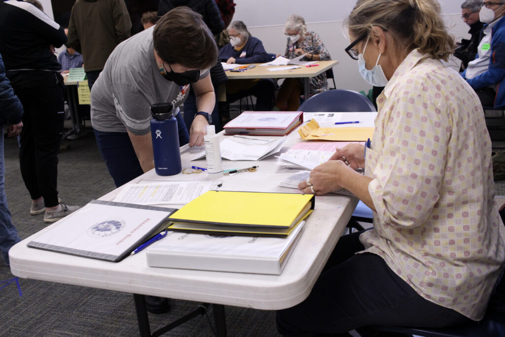 Chief Inspector Megan Williamson processes absentee ballots at the Hawthorne Library on Madison's East Side during the November 2022 election. (Photo by Henry Redman/Wisconsin Examiner)