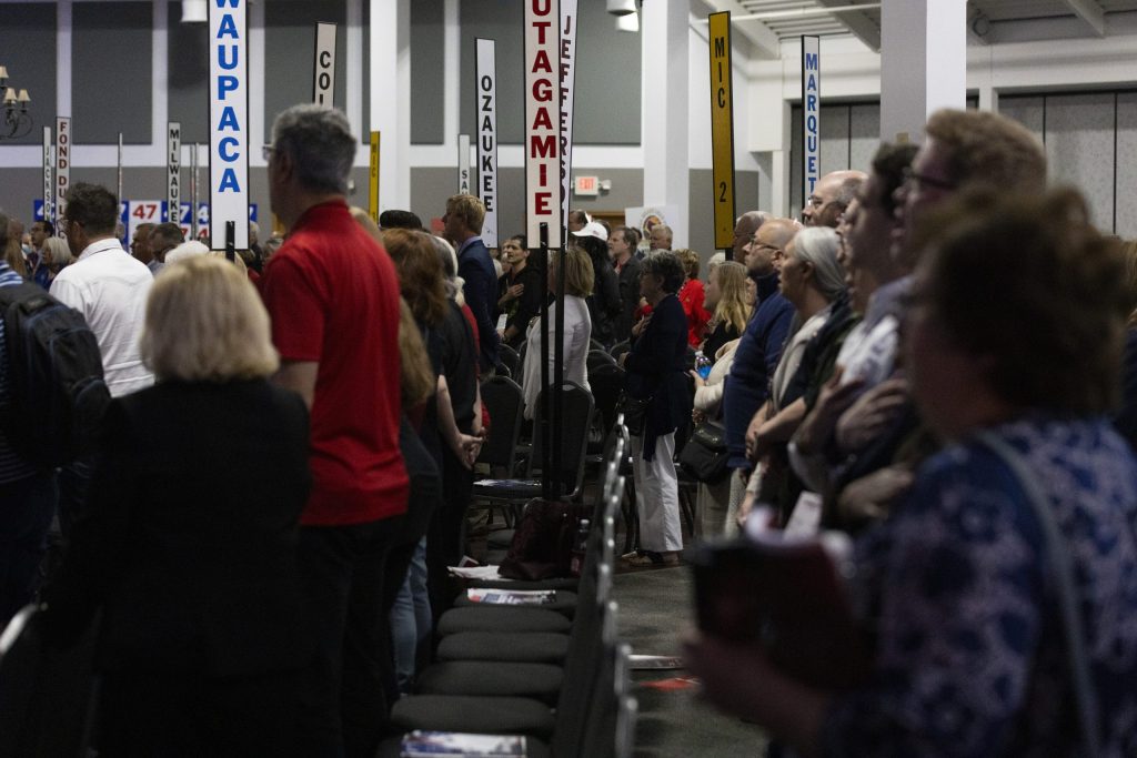 Attendees sing along to the national anthem during the Republican Party of Wisconsin convention on May 17, 2025, at the Central Wisconsin Convention & Expo Center in Rothschild, Wis. (Joe Timmerman / Wisconsin Watch)