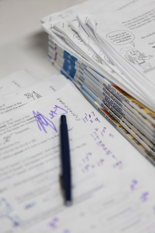 Coursework designed by Matthew Jacobson is stacked on a table in his classroom at Brookfield Elementary School on May 22, 2026. Jacobson applies lessons he learns from his college courses directly into his work with students. (Joe Timmerman / Wisconsin Watch)