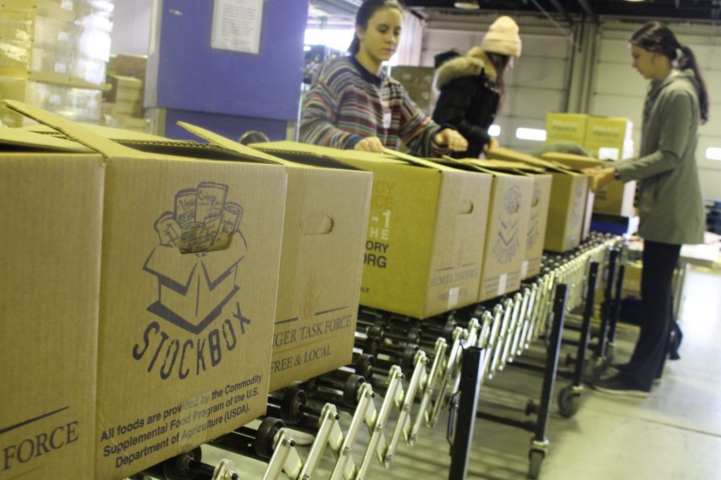 Volunteers with Hunger Task Force in Milwaukee load boxes with food to be distributed to senior citizens. Courtesy of Hunger Task Force