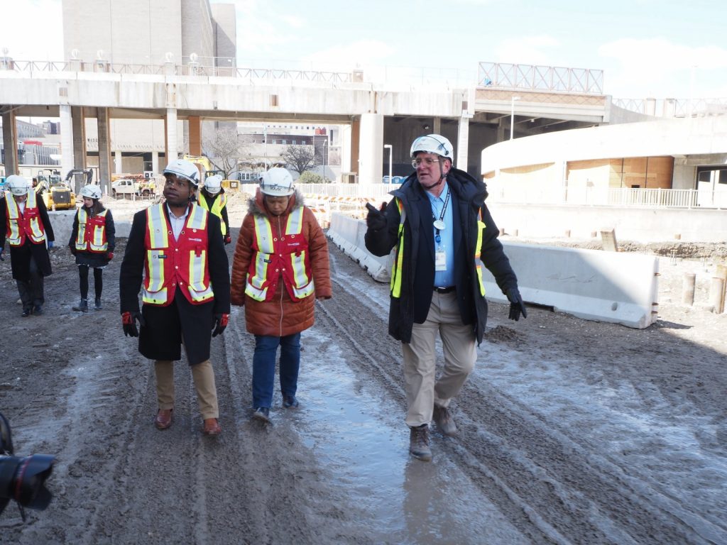 Marty Brooks (right) leads Mayor Cavalier Johnson (left) and an aide on a 2022 tour of the Baird Center expansion project. Photo by Jeramey Jannene.