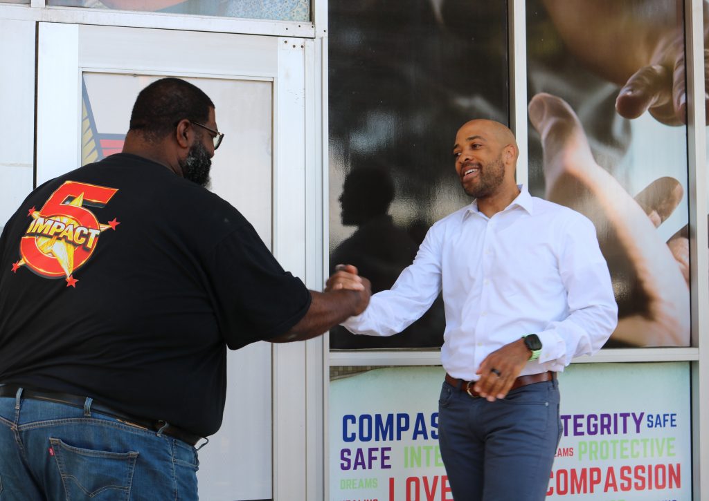 Mandela Barnes (right) greets Jacob Gatlin, community liaison for Five Star Impact, during a campaign stop Tuesday. Photo taken June 16, 2026 by Sophie Bolich.