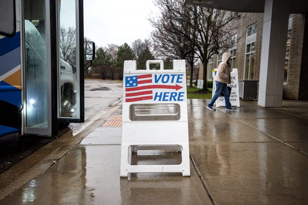 Beloit residents walk through the rain on their way to vote Tuesday, April 2, 2024, at the Beloit Public Library. Angela Major/WPR
