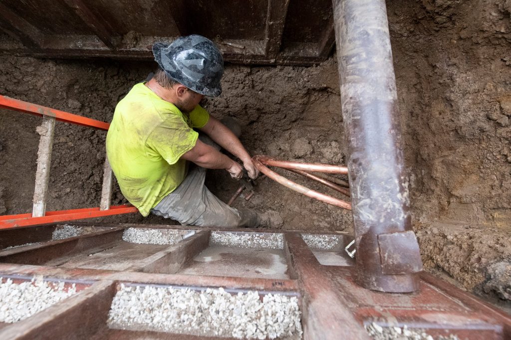 A worker flares copper tubing as a crew swaps out a lead water service line for copper pipes in Milwaukee on June 29, 2021. Isaac Wasserman/Wisconsin Watch