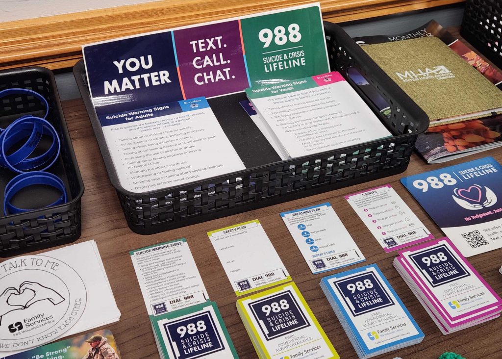 Pamphlets, cars and wristbands aimed at raising awareness for suicide prevention are see inside the Family Services of Northeast Wisconsin office on Friday, June 26, 2026. Joe Schulz/WPR