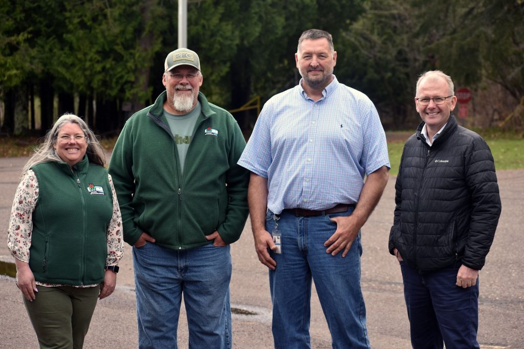 Justine Hasz, Darren Miller, David Giehtbrock and Eric Lobner with the Wisconsin Department of Natural Resources stand outside the Les Voigt State Fish Hatchery in Bayfield. Danielle Kaeding/WPR