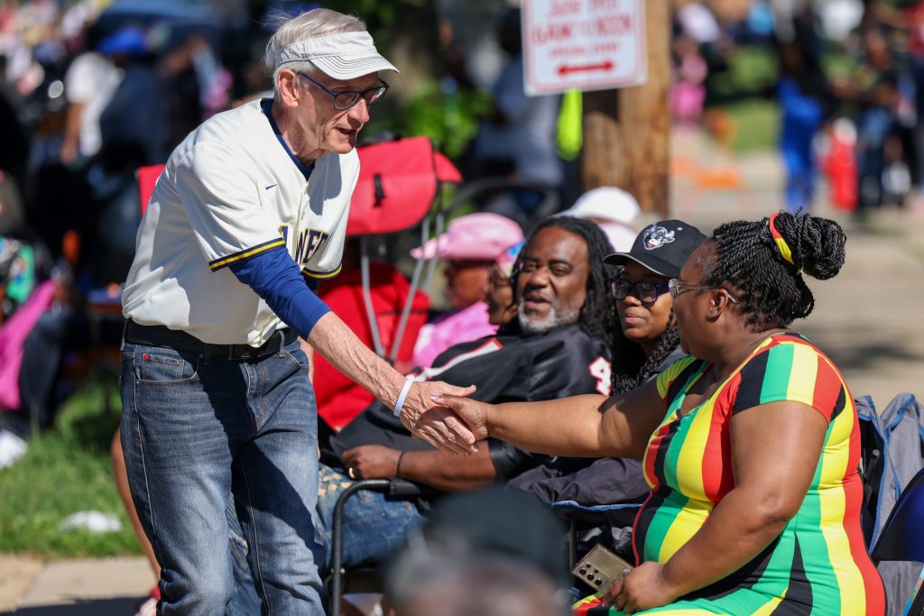 Gov. Tony Evers shakes hands with attendees during the 55th Juneteenth Jubilee Parade.