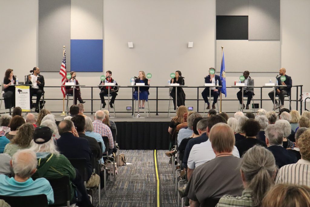 During one round of questions, participants were given “yes” and “no” paddles to hold up in answer to questions. (Photo by Isiah Holmes/Wisconsin Examiner)
