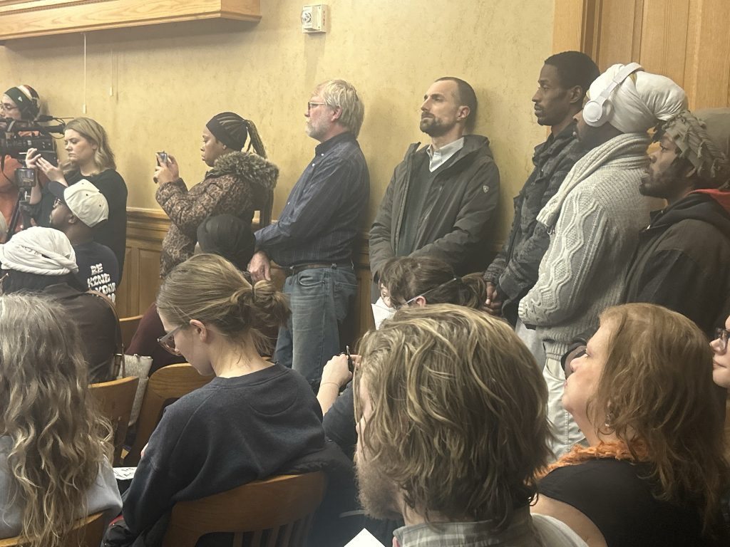 People fill a Milwaukee Fire and Police Commission meeting protesting Flock and facial recognition technology. (Photo by Isiah Holmes/Wisconsin Examiner)