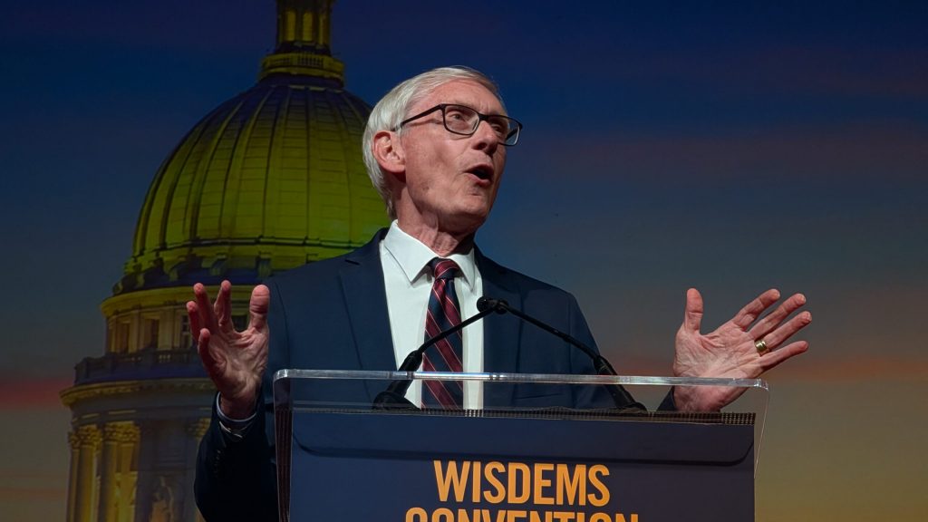 “You’ve probably heard of a guy named Tom Tiffany,” Evers said to booing from delegates, referring to the Republican U.S. representative running for governor. “Maybe you haven’t. We can’t all be the most popular elected official in the state.” (Photo by Baylor Spears/Wisconsin Examiner)