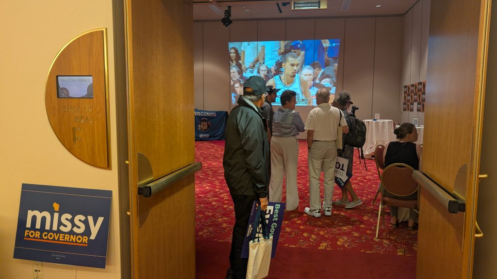 Missy Hughes watches the Knicks v. Spurs game in her hospitality suite with party activists. (Photo by Baylor Spears/Wisconsin Examiner)