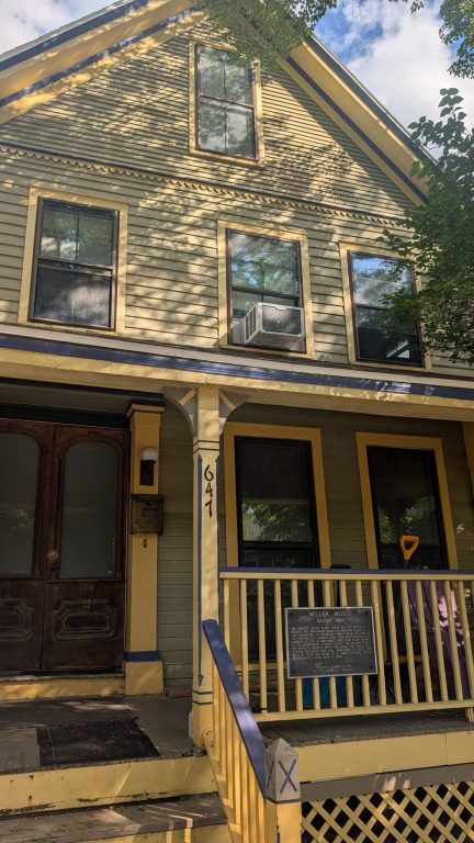 A yellow and blue house next door home was the home of William and Anna Mae Miller. (Photo by Baylor Spears/Wisconsin Examiner)