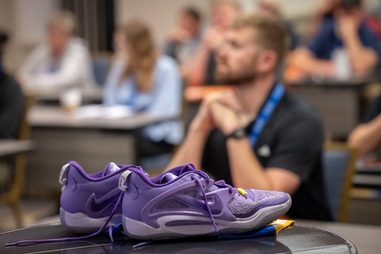 A pair of Landen Weigelt’s football cleats sit on a table during a training conference for school resource officers. Jamie and Jared Weigelt have shared their son’s story at high schools across northeast Wisconsin in hopes of preventing another tragedy. (Mike Roemer for Wisconsin Watch)