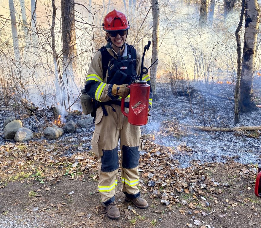 AmeriCorps member Callie Grones helps out with the first prescribed burn on Wisconsin Point in more than a century. Photo courtesy of Deanna Erickson/Lake Superior National Estuarine Research Reserve