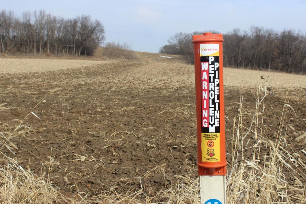 An Enbridge post marks the Line 61 corridor near Keith Reopelle’s property in Marshall, Wisconsin. Bridgit Bowden/WPR