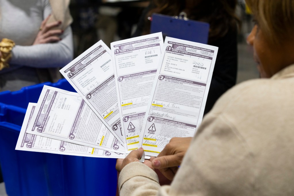 Stephanie Rushing, Milwaukee Election Commission election services coordinator, sorts through rejected absentee ballots on Election Day, Nov. 5, 2024, at Milwaukee's central count site at the Baird Center in Milwaukee. (Joe Timmerman / Wisconsin Watch)