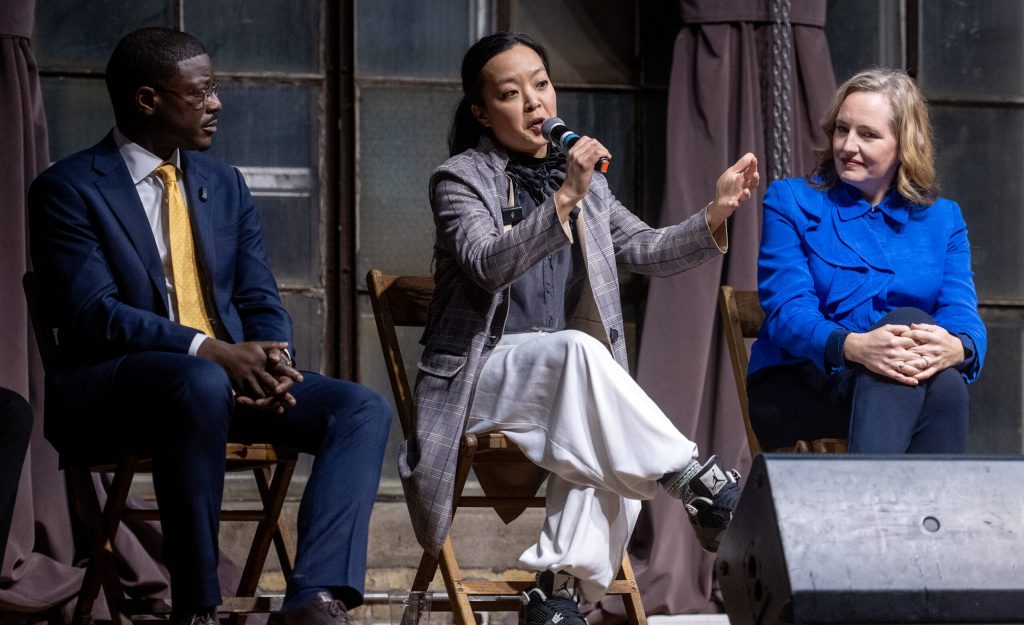 Rep. Francesca Hong, center, speaks to attendees at a governor candidate forum while sitting between Milwaukee County Executive David Crowley, left, and Sen. Kelda Roys, right, on Wednesday, Jan. 21, 2026, at the Cooperage in Milwaukee, Wis. Angela Major/WPR