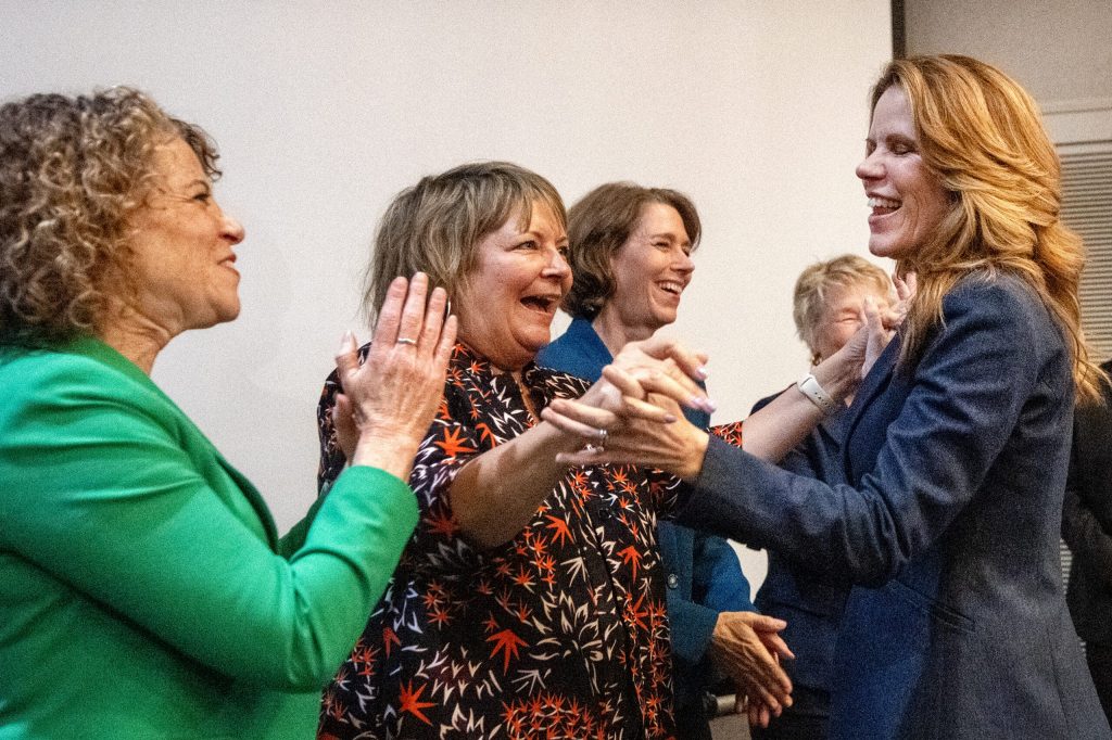Judge Chris Taylor, right, is greeted by Wisconsin Supreme Court justices during her election night event Tuesday, April 7, 2026, at the Madison Concourse Hotel in Madison, Wis. Angela Major/WPR