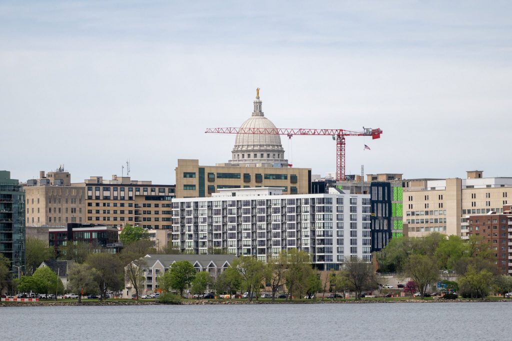A crane stretches across the Madison skyline Tuesday, April 28, 2026, in Madison, Wis. Angela Major/WPR