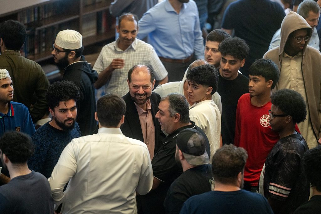 Salah Sarsour is greeted by members of his community Friday, June 19, 2026, at the Islamic Society of Milwaukee in Milwaukee, Wis. Angela Major/WPR