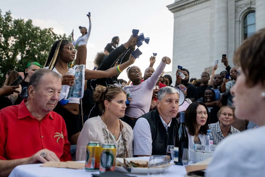 Protesters approach attendees of a Concerts on the Square event Wednesday, July 22, 2026, in Madison, Wis, after a Madison man was shot and killed by a police officer earlier that day. Angela Major/WPR