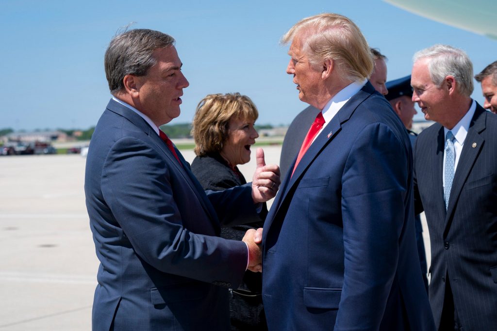 Paul Farrow, Waukesha County executive, left, shakes hands with President Donald Trump after the president arrived at General Mitchell International Airport Friday, on July 12, 2019. Tia Dufour/National Archives and Records Administration
